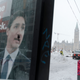 A graffitied image of Prime Minister Justin Trudeau is seen as city employees clean up Wellington Street in front of Parliament Hill, previously occupied by the Freedom Convoy, in Ottawa, Ontario, Canada, on February 20, 2022. - The last big rigs were being towed Sunday out of Canada’s capital, where the streets were quiet for the first time in three weeks after a massive police operation ended a drawn-out siege over Covid health rules.